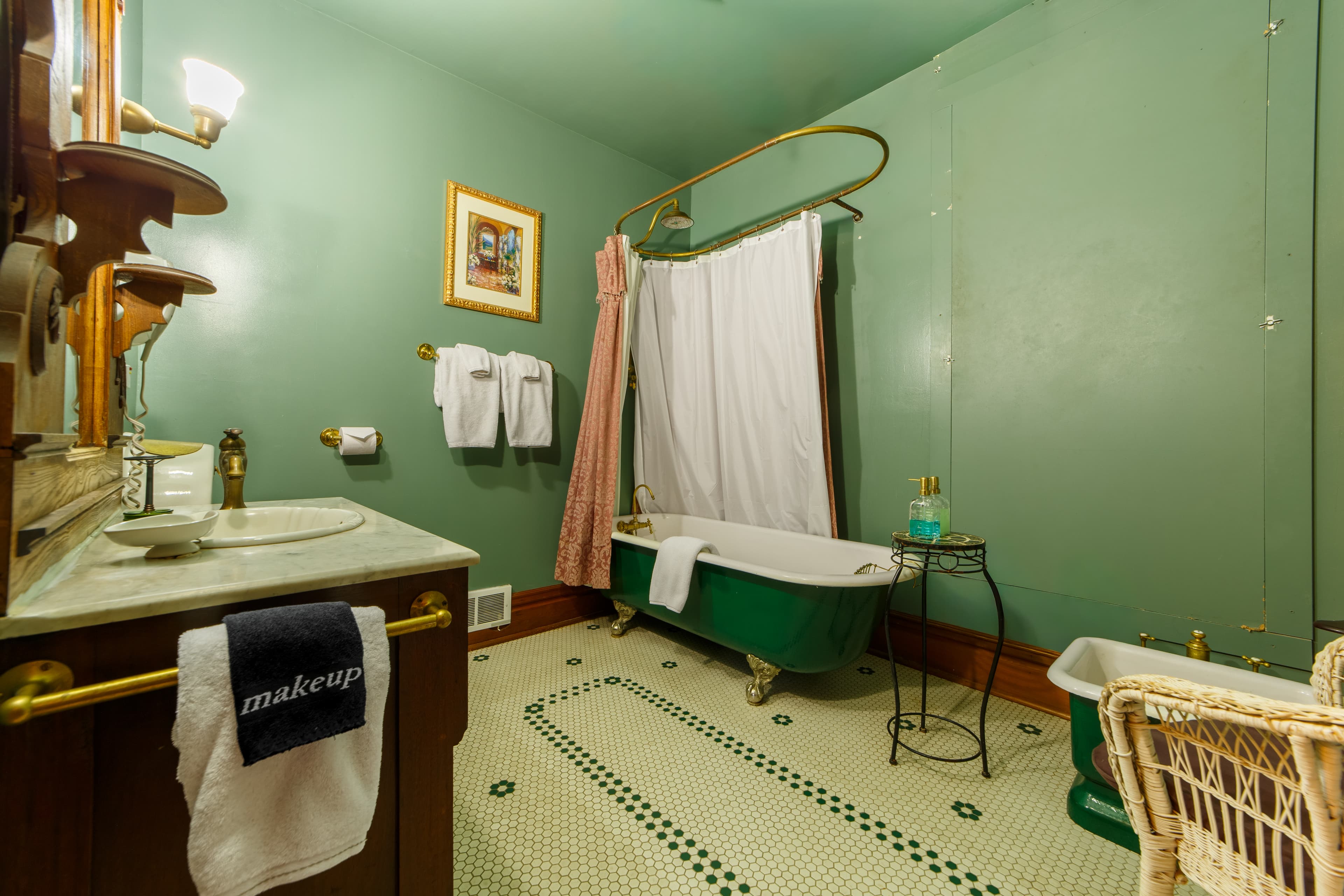 Private bath across hallway, with claw foot tub and shower above.