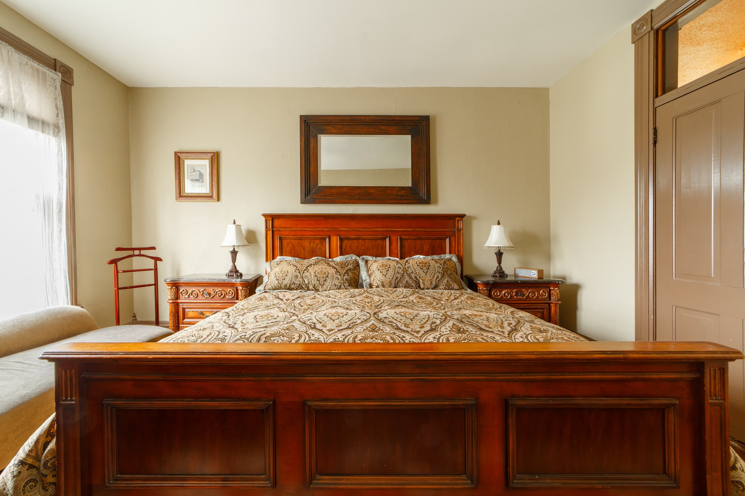 King size bed with large side tables with drawers for storage.