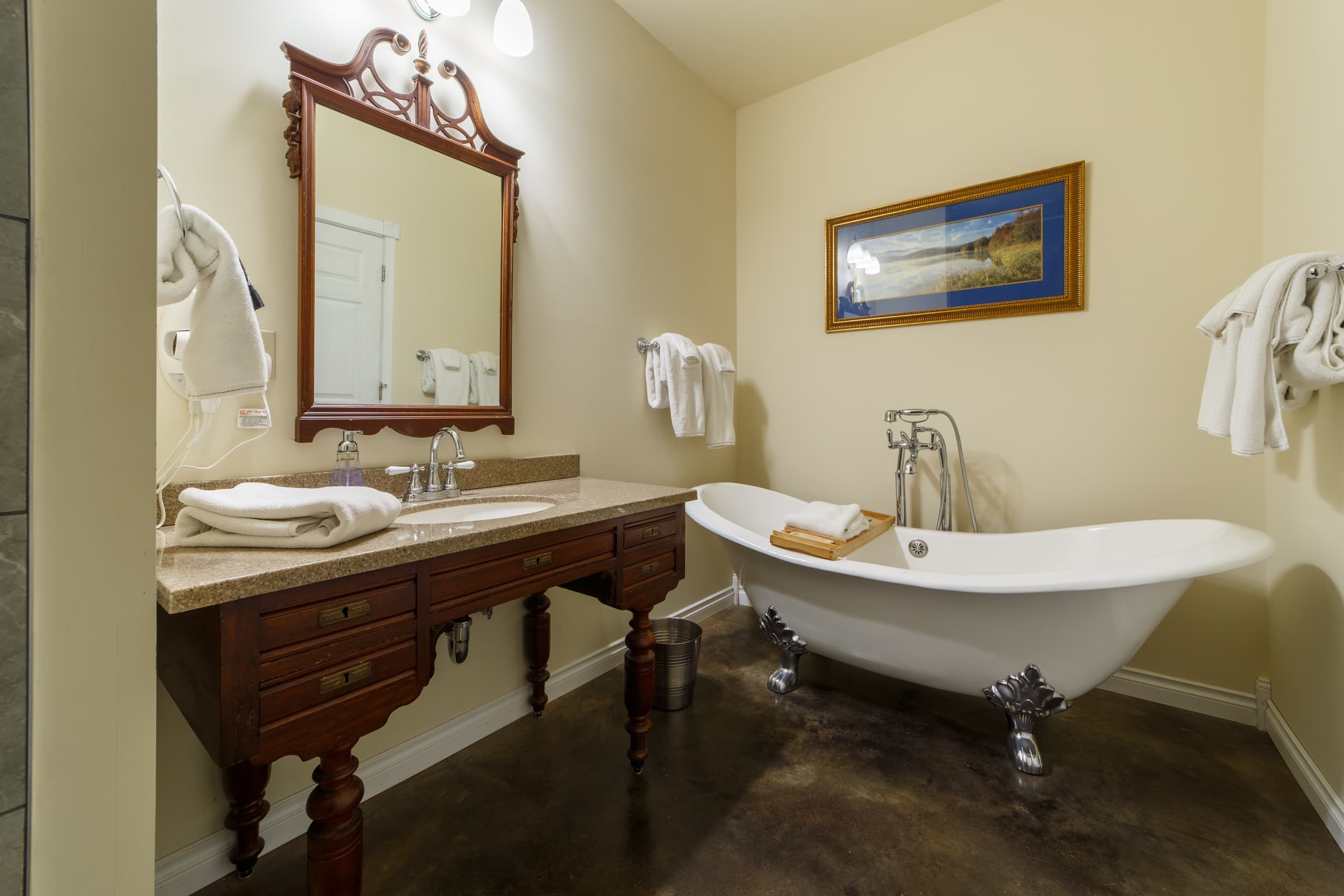 Larger bathroom with tub, vanity and walk-in shower.